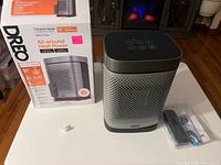 Heater next to box with remote and batteries