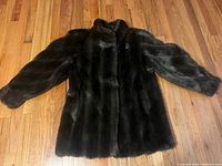 Full view of coat laid flat front