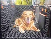 Marketing image showing installed black quilted back seat pet extender with dog
