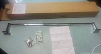 Towel bar, hardware bags, instruction sheet beside original box