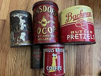 Five tins front view showing branding
