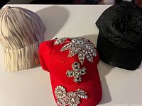 Front view of all three caps showing colors, patterns, rhinestones, quilted texture