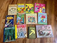 All 12 books laid out on floor