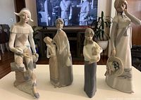 Front view of all four Casades porcelain figurines