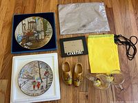 All items laid out: two plates, two bags, frame, clogs, glass pieces