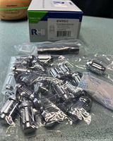 Sealed bag of chrome spline lug nuts beside RHI Automotive box