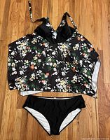 Front view of floral halter tankini top and black bottoms