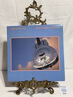 Front cover of Dire Straits Brothers In Arms LP on stand