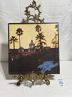 Front cover of Eagles Hotel California vinyl LP on display stand
