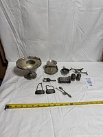 Group shot of all silver plate items with tape for scale