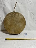 Full view of drum front with measuring tape for scale