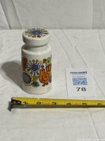 Full view of ceramic sugar sifter with measuring tape