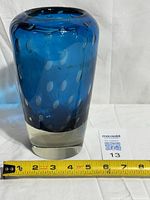 Front view of blue art glass vase with clear base