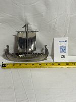 Full view of pewter Viking ship with tape measure for scale (≈7 in.)