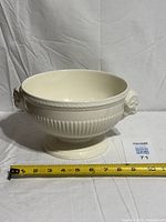 Front view of footed bowl with measuring tape showing overall width
