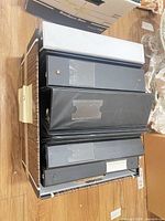 Stack of black binders showing spine label pockets and ring thickness