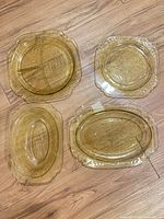 Group shot of all four amber pressed glass pieces