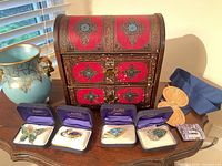 Lot overview showing jewelry chest, vase, jewelry boxes, medals