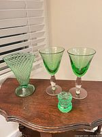 Overall view of all four green uranium glass pieces