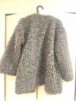 Back view of faux fur coat showing overall texture