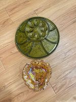 Olive green deviled egg platter above amber bowl