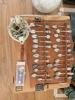 Overall lot showing rack filled with souvenir spoons and boxed spoon