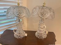 Pair of cut crystal table lamps on wooden surface
