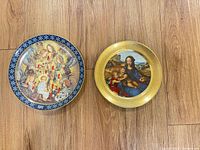 Both Pickard plates side by side on wood floor