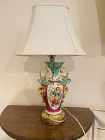 Full view of porcelain table lamp with shade