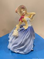 Front view of Royal Doulton Autumn Breezes figurine showing full attire and colors
