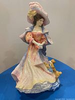 Front view of Royal Doulton Katherine figurine showing lady, gown, dog