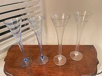 Group shot of four champagne flutes: two clear, two blue