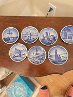 All seven plates displayed front view on tabletop