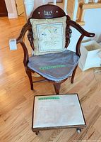 Front view of armchair with pillow, seat pad, and ottoman