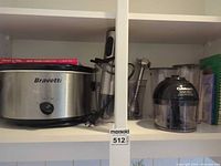 Shelf showing Bravetti slow cooker and Cuisinart immersion blender components
