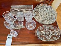Group shot of entire cut glass serving set displayed on table