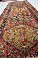 Oblique view showing central diamond medallions and colour palette