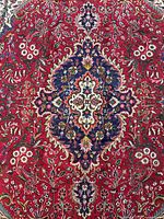 Central medallion and floral detail of rug