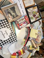 Overall lot overview showing wall art, photo albums, chopping mats and accessories