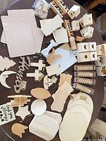 overview of assorted unfinished wood blanks on table