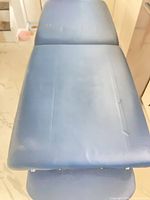 Top surface of blue massage table showing overall condition