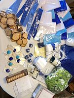 Assorted linens, wood slices, flowers, beads on table