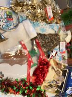 Overview of tinsel garlands, felt ornament kits, brass bugle and assorted small decorations