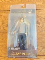 Front view of sealed Jasper action figure in packaging