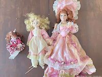 All three porcelain dolls side by side showing scale and outfits