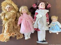 Group shot of four Victorian style porcelain dolls