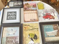 All eight framed prints laid out on table