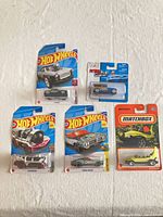 Front view of all five sealed die-cast cars