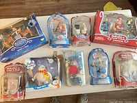 All eight packaged figures laid out on table