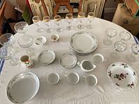 Entire assortment of china and glassware laid out on table